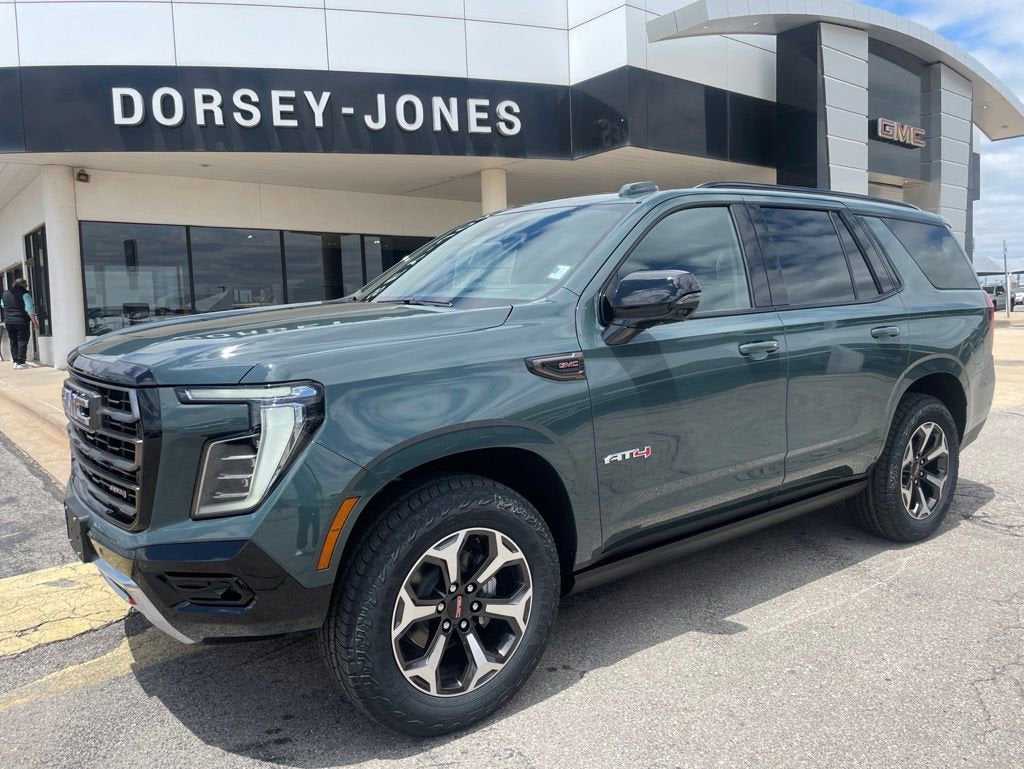 2026 GMC Yukon AT4 Ultimate in Midnight Pine — front three-quarter view